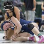 Lake Stevens Lily Ganal grimaces as she tries to get control of the wrist of Glacier Peaks Eliana Sherve during the 130-pound match at the 4A girls wrestling district tournament on Friday, Feb. 7, 2025 in Mill Creek, Washington. (Olivia Vanni / The Herald)