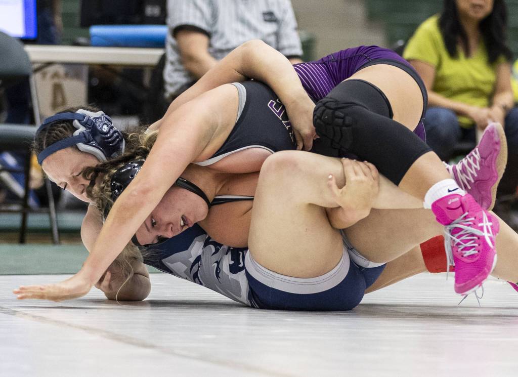 Lake Stevens Dallas Kautz rolls Glacier Peaks Samantha Wilner onto her back during the 170-pound match at the 4A girls wrestling district tournament on Friday, Feb. 7, 2025 in Mill Creek, Washington. (Olivia Vanni / The Herald)