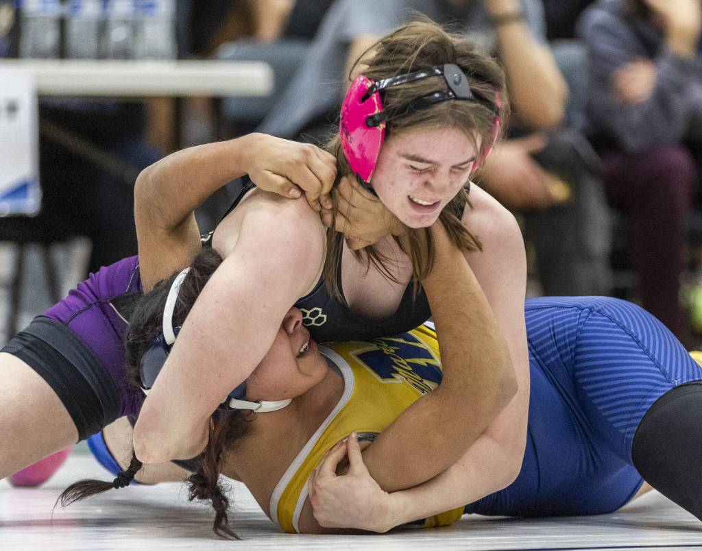 Lake Stevens Kylee Wicklund grimaces as she tries to push Mariners Jannethzy Cortes-Hernandez into the mat during the 140-pound match at the 4A girls wrestling district tournament on Friday, Feb. 7, 2025 in Mill Creek, Washington. (Olivia Vanni / The Herald)