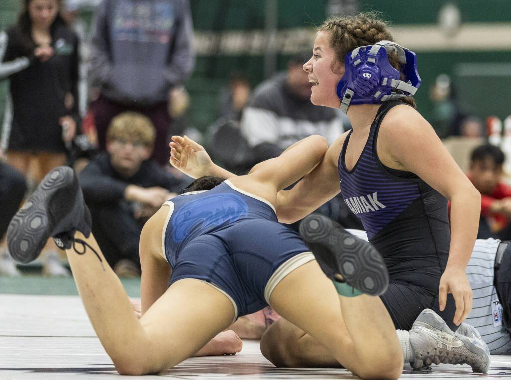Kamiaks Kai Burgess looks up at her coaches and smiles after beating Arlingtons Jaymari ONeal in the 125-pound match at the 4A girls wrestling district tournament on Friday, Feb. 7, 2025 in Mill Creek, Washington. (Olivia Vanni / The Herald)