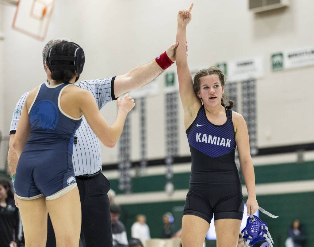 Kamiaks Kai Burgess has her arm raised in the air after beating Arlingtons Jaymari ONeal in the 125-pound match at the 4A girls wrestling district tournament on Friday, Feb. 7, 2025 in Mill Creek, Washington. (Olivia Vanni / The Herald)
