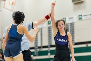 Kamiak’s Kai Burgess has her arm raised in the air after beating Arlington’s Jaymari O’Neal in the 125-pound match at the 4A girls wrestling district tournament on Friday, Feb. 7, 2025 in Mill Creek, Washington. (Olivia Vanni / The Herald)