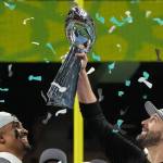 Philadelphia Eagles quarterback Jalen Hurts (1) smiles as head coach Nick Sirianni holds up the Lombardi trophy after they defeated the Kansas City Chiefs 40-22 in Super Bowl LIX at Caesars Superdome in New Orleans, Sunday, Feb. 9, 2025. (Timothy A. Clary / AFP / Getty Images / Tribune News Services)