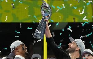 Philadelphia Eagles quarterback Jalen Hurts (1) smiles as head coach Nick Sirianni holds up the Lombardi trophy after they defeated the Kansas City Chiefs 40-22 in Super Bowl LIX at Caesars Superdome in New Orleans, Sunday, Feb. 9, 2025. (Timothy A. Clary / AFP / Getty Images / Tribune News Services)