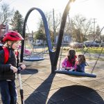 Alina Langbehn, 6, center, and Vera A., 6, right, sit on a swing together at Drew Nielsen Neighborhood Park after school on Tuesday, Jan. 28, 2025 in Everett, Washington. (Olivia Vanni / The Herald)