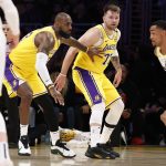 LeBron James (23) and Luka Doncic (77) of the Los Angeles Lakers look on as John Collins (20) of the Utah Jazz drives to the basket during the first quarter at Crypto.com Arena on Monday, Feb. 10, 2025, in Los Angeles. (Ronald Martinez / Getty Images / Tribune News Services)