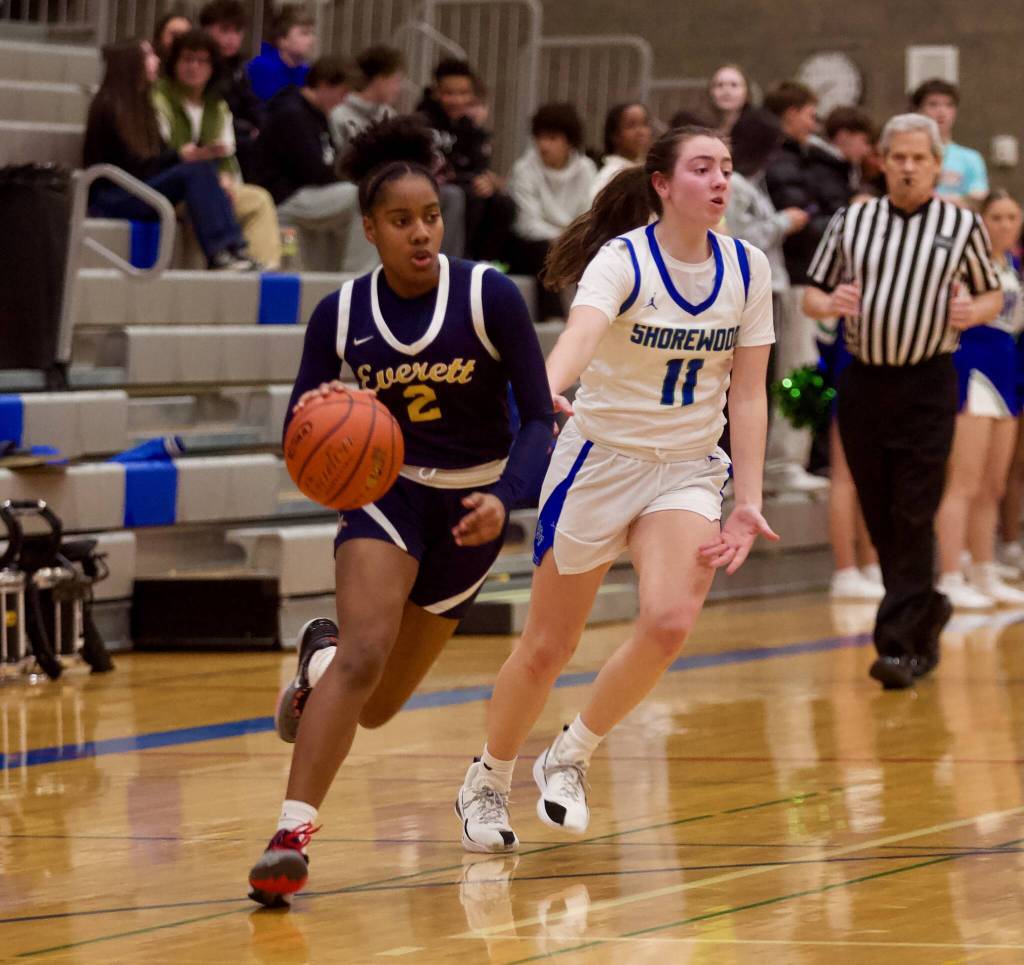 Everett junior Akilah Shaw (2) dribbles past Shorewood senior Bridget Cox (11) in Shorewood's 41-30 win in the opening round of the District 1 3A Girls Tournament on Wednesday, Feb. 12, 2025 in Shoreline, Washington. (Joe Pohoryles / The Herald)