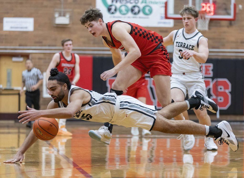 Mountlake Terraces Svayjeet Singh leaps in the air after the basketball during the 3A district loser-out playoff game against Snohomish on Thursday, Feb. 13, 2025 in Mountlake Terrace, Washington. (Olivia Vanni / The Herald)