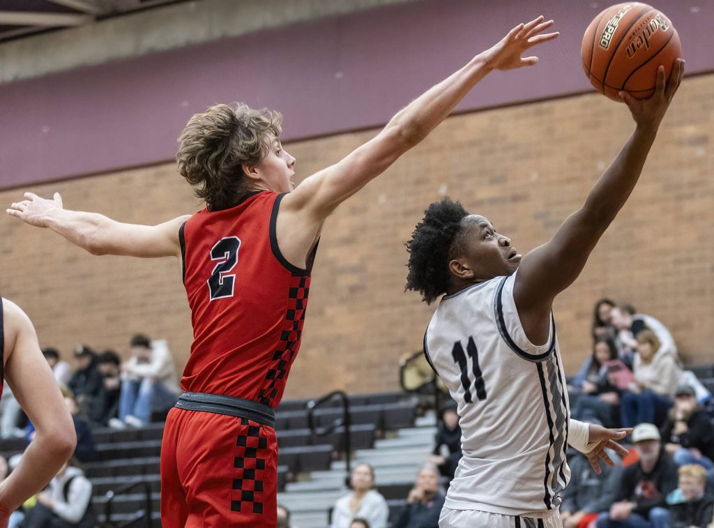Snohomishs Bryson Wheat tries to reach out a block a layup by Mountlake Terraces Rayshaun Connor during the 3A district loser-out playoff game on Thursday, Feb. 13, 2025 in Mountlake Terrace, Washington. (Olivia Vanni / The Herald)