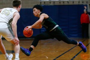 Marysville Getchell junior Bubba Palocol reverses directions while dribbling against Arlington during a playoff matchup at Arlington High School on Saturday, Feb. 24, 2024, in Arlington, Washington. (Ryan Berry / The Herald)