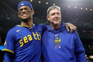 Julio Rodríguez (left) and manager Dan Wilson (right) of the Seattle Mariners react after the game against the Oakland Athletics at T-Mobile Park on Sept. 27, 2024, in Seattle, Washington. (Steph Chambers / Getty Images / Tribune News Services)