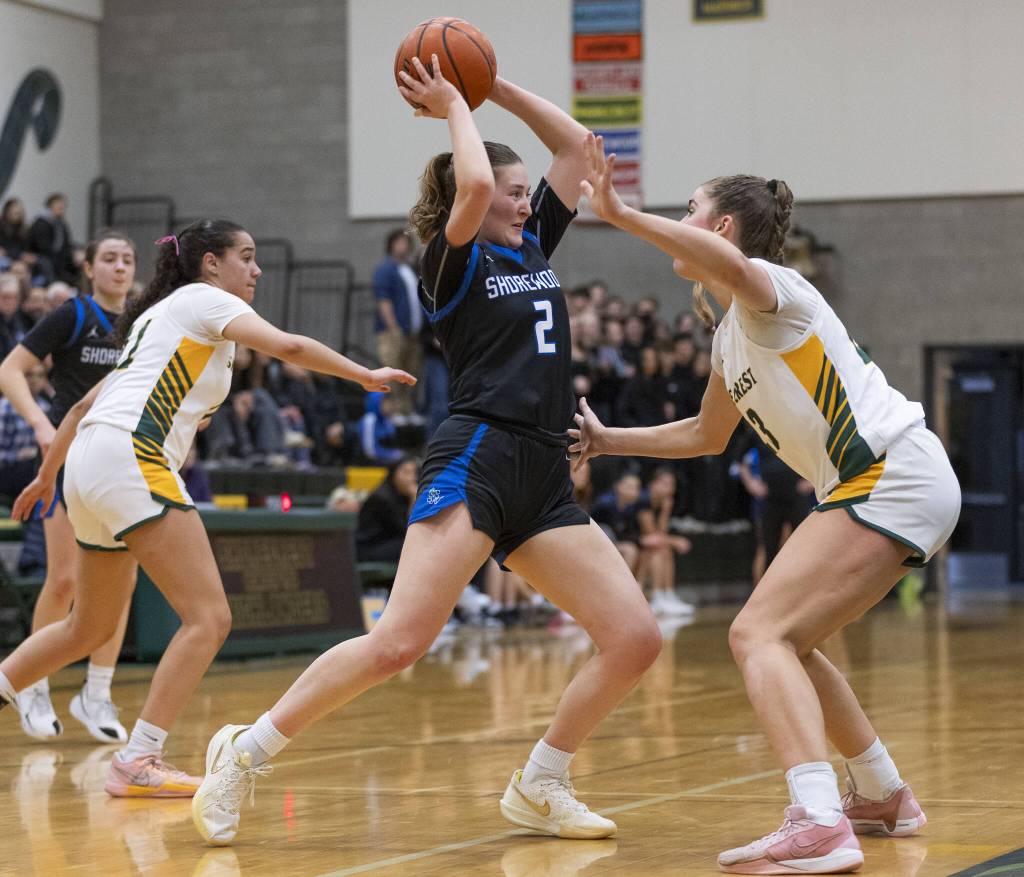 Shorewoods Lilly Marter tries to the pass the ball over the top of Shorecrests Cassie Chesnut during the 3A district playoff game on Friday, Feb. 14, 2025 in Shoreline, Washington. (Olivia Vanni / The Herald)