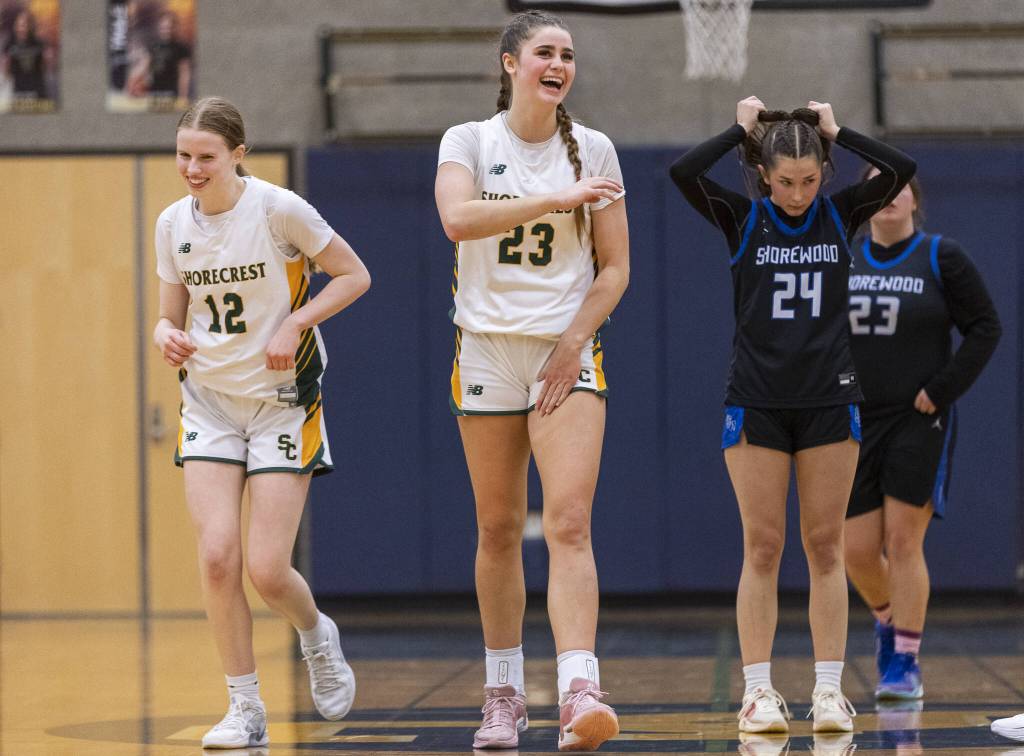 Shorecrests Jorja Perrin and Cassie Chesnut laugh as they pull ahead of Shorewood in the final second of the 3A district playoff game on Friday, Feb. 14, 2025 in Shoreline, Washington. (Olivia Vanni / The Herald)