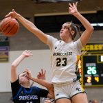 Shorecrest’s Cassie Chesnut leaps in the air to block a shot by Shorewood’s Bridget Cox during the 3A district playoff game on Friday, Feb. 14, 2025 in Shoreline, Washington. (Olivia Vanni / The Herald)