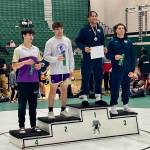 Arlington junior Tre Haines stands atop the podium after winning the District 1 Boys 4A Wrestling 157-pound championship on Feb. 8 in Mill Creek, Washington. Lake Stevens senior Jarrell David placed second, Arlington junior Marquell Butler placed third and Lake Stevens sophomore Felix Ramsey placed fourth in the weight class. (Joe Pohoryles / The Herald).