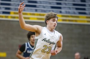 Arlington’s Leyton Martin puts three fingers in the air after making a three point shot during the game against Glacier Peak on Friday, Jan. 17, 2025 in Arlington, Washington. (Olivia Vanni / The Herald)