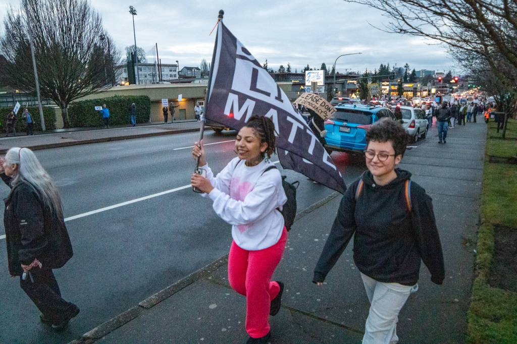 Aaron Kennedy / Daily Herald 
In a gathering similar to many others across the nation on Presidents Day, hundreds lined Broadway with their signs and chants to protest the Trump administration Monday evening in Everett.