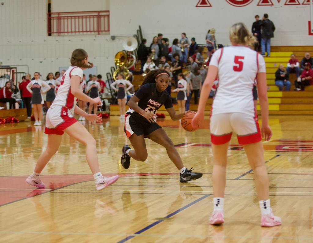 Monroe senior Halle Keller looks to split a couple Stanwood defenders in the Girls 3A Basketball District 1 semifinals at Marysville Pilchuck High School in Marysville, Washington on Feb. 18, 2025. (Joe Pohoryles / The Herald)