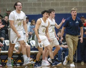 The Arlington bench reacts to a three point shot during the game against Glacier Peak on Friday, Jan. 17, 2025 in Arlington, Washington. (Olivia Vanni / The Herald)