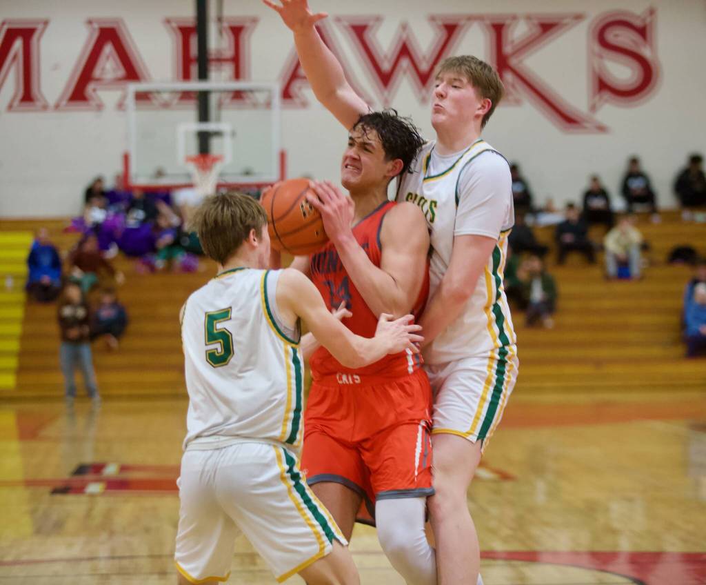Monroe junior Chayce Waite-Kellar pulls in a rebound against Shorecrest junior Brayden Fischer (5) and sophomore Jack Thompson during the District 1 Boys 3A Basketball Semifinals in Marysville, Washington on Feb. 19, 2025. (Joe Pohoryles / The Herald)