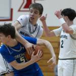 Shorewoods Thomas Moles and Edmonds-Woodways William Alseth look to the referees for a jump ball call during the 3A district semifinal game on Wednesday, Feb. 19, 2025 in Marysville, Washington. (Olivia Vanni / The Herald)