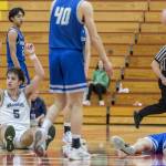 Edmonds-Woodways Cam Hiatt puts his fingers up in the air in celebration after hitting a half-court shot at the halftime buzzer during the 3A district semifinal game against Shorewood on Wednesday, Feb. 19, 2025 in Marysville, Washington. (Olivia Vanni / The Herald)
