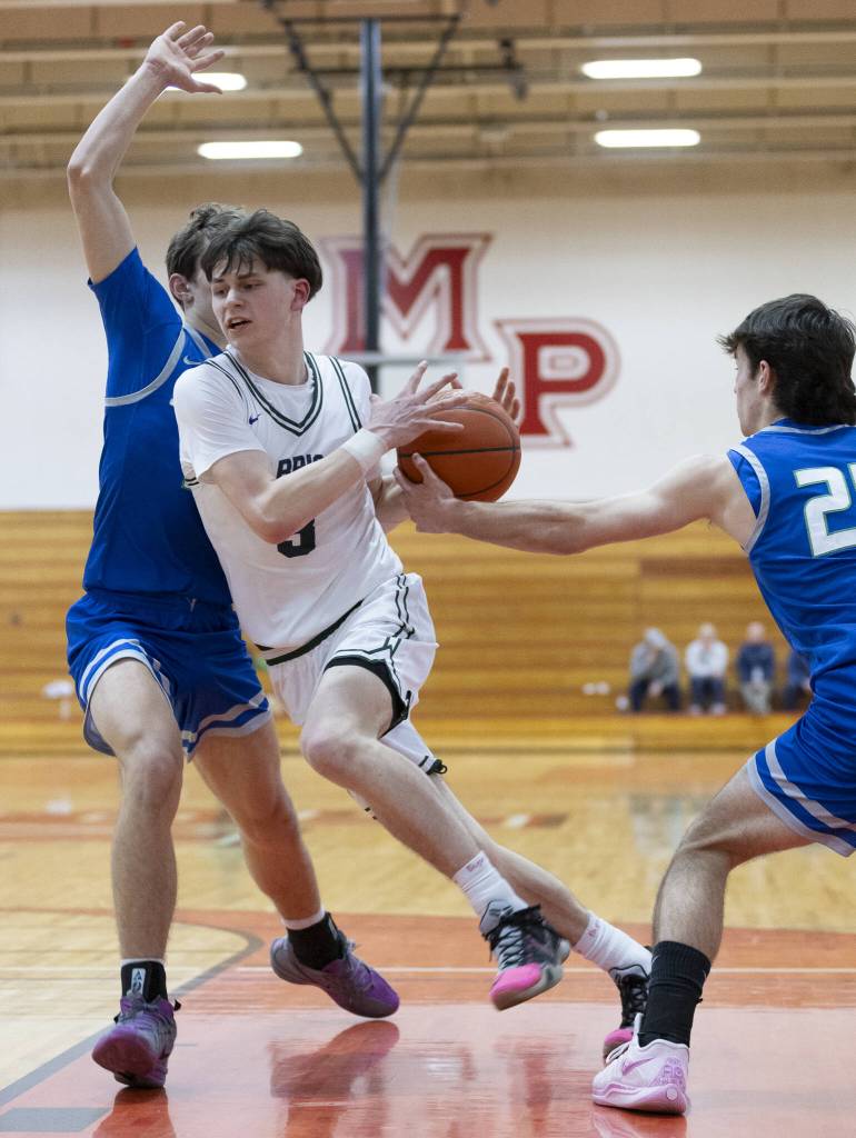 Edmonds-Woodways Grant Williams is fouled while taking the ball to the hoop during the 3A district semifinal game against Shorewood on Wednesday, Feb. 19, 2025 in Marysville, Washington. (Olivia Vanni / The Herald)