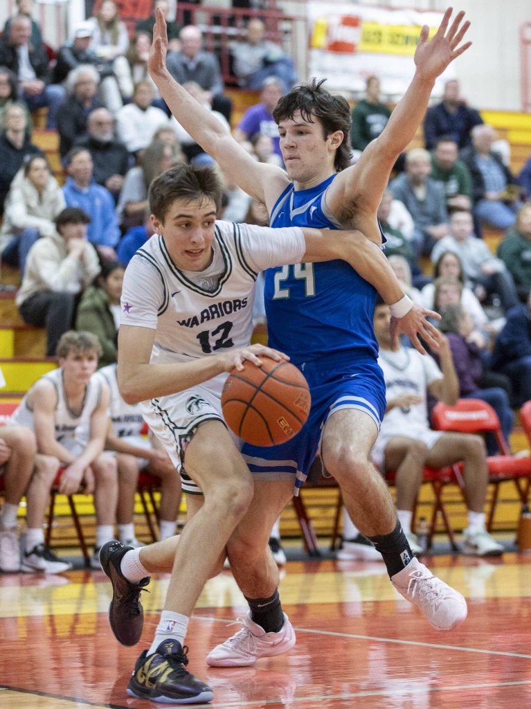 Edmonds-Woodways William Alseth tries to dribble around Shorewoods Jaden Marlow during the 3A district semifinal game on Wednesday, Feb. 19, 2025 in Marysville, Washington. (Olivia Vanni / The Herald)