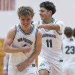 Edmonds-Woodways Cavan Schillinger laughs with a teammate during the 3A district semifinal game on Wednesday, Feb. 19, 2025 in Marysville, Washington. (Olivia Vanni / The Herald)