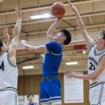 Edmonds-Woodways Julian Gray and Luke Boland both reach up to try and block a shot by Shorewoods Max Nguyen during the 3A district semifinal game on Wednesday, Feb. 19, 2025 in Marysville, Washington. (Olivia Vanni / The Herald)