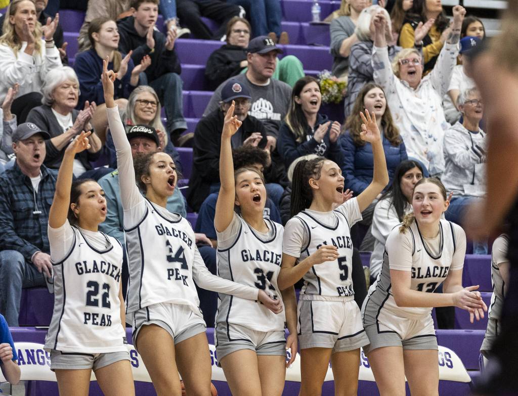 The Glacier Peak bench and fan react to a 3-point shot during the 4A district loser-out playoff game against North Creek on Thursday, Feb. 20, 2025 in Kirkland, Washington. (Olivia Vanni / The Herald)