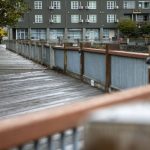 A person walks in the rain at the Port of Everett in Everett, Washington on Saturday, Sept. 23, 2023. (Annie Barker / The Herald)