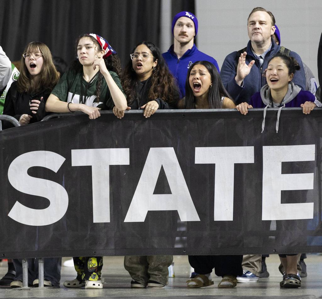 Fans cheer on their wrestlers at the Mat Classic on Friday, Feb. 21, 2025 in Tacoma, Washington. (Olivia Vanni / The Herald)
