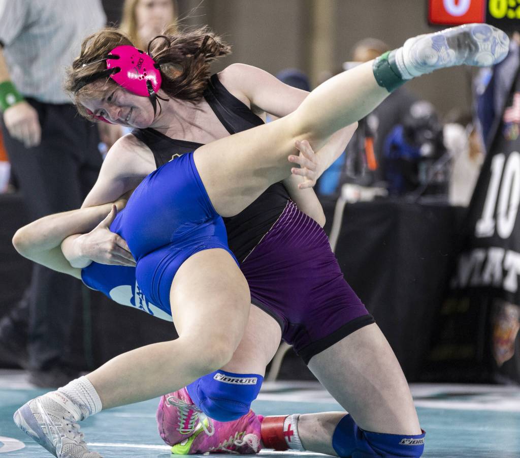 Lake Stevens Kylee Wicklund flips her opponent over during the 4A girls 145-pound championship match at the Mat Classic on Friday, Feb. 21, 2025 in Tacoma, Washington. (Olivia Vanni / The Herald)