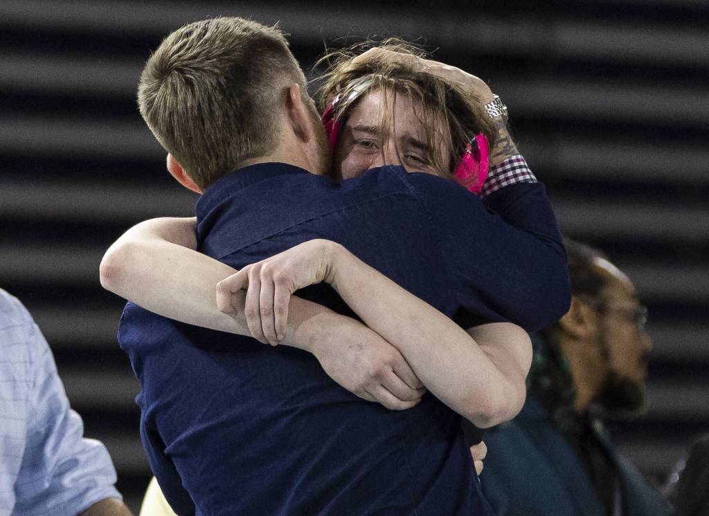 Lake Stevens Kylee Wicklund cries while hugging her coach after winning the 4A girls 145-pound title at the Mat Classic on Friday, Feb. 21, 2025 in Tacoma, Washington. (Olivia Vanni / The Herald)