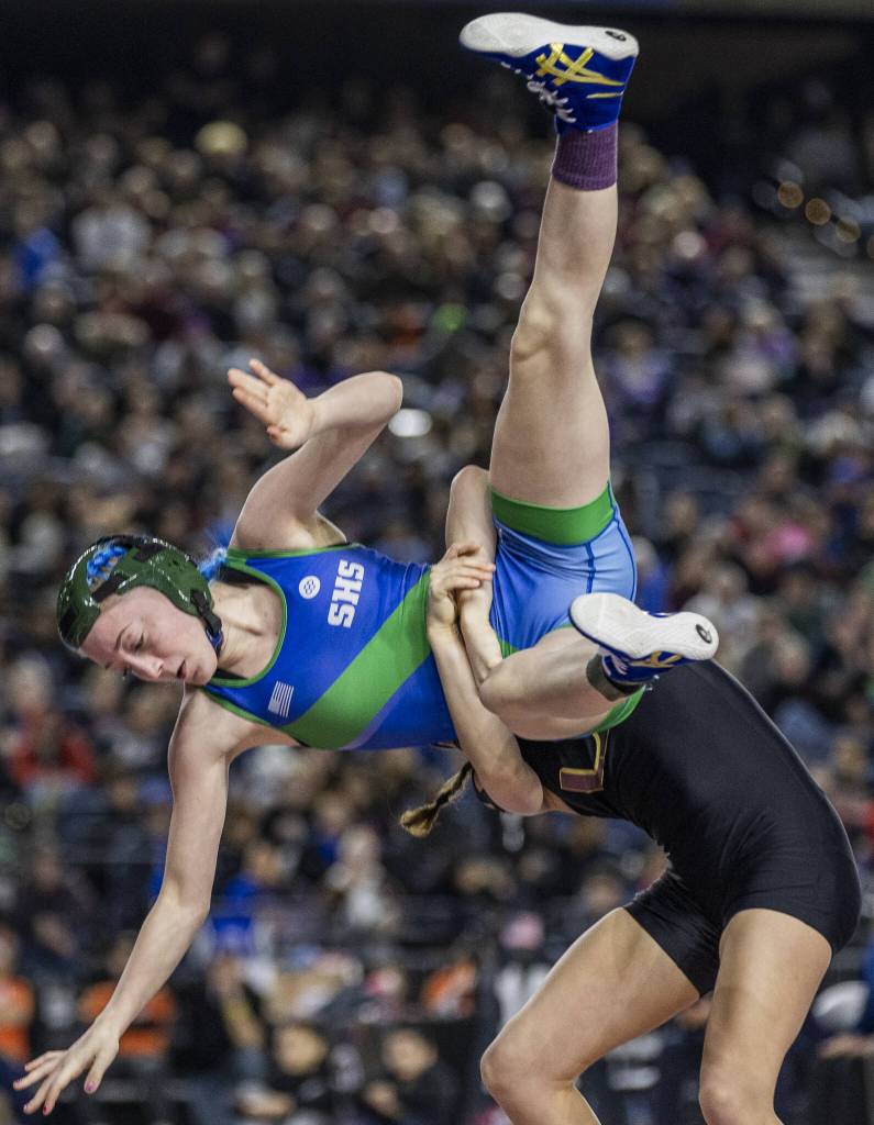 Shorewoods Finley Houck is flipped in the air during the 3A girls 115-pound championship match at the Mat Classic on Friday, Feb. 21, 2025 in Tacoma, Washington. (Olivia Vanni / The Herald)
