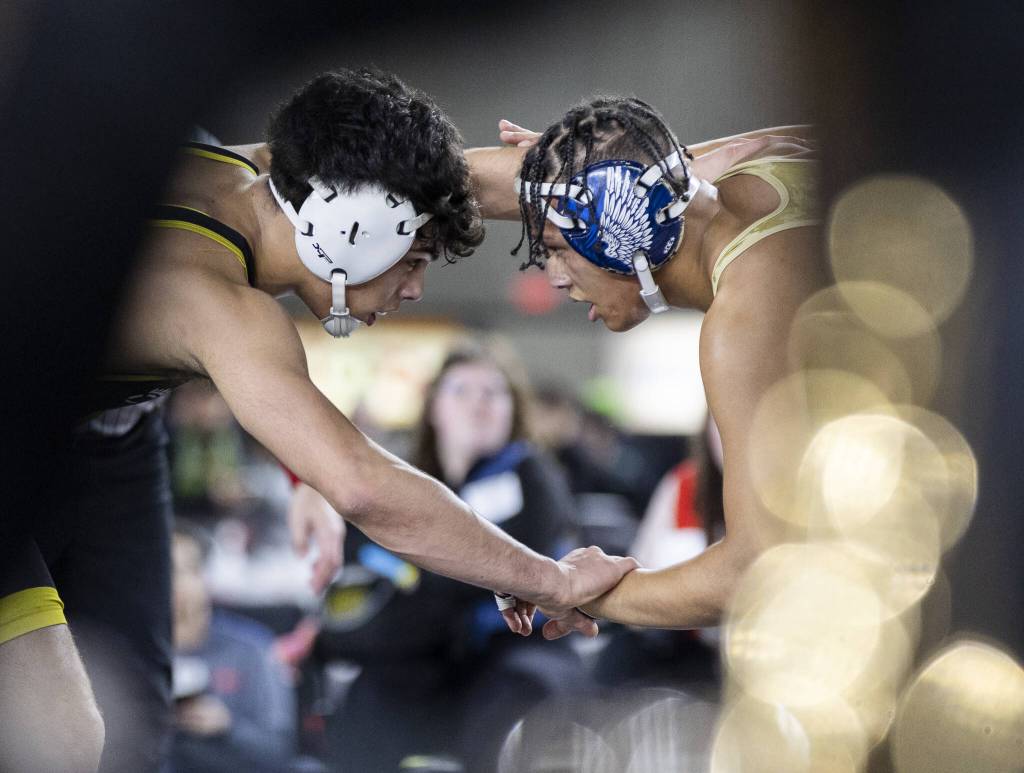 Arlingtons Tre Haines hand fights with his opponent during the 4A boys 165-pound championship match at the Mat Classic on Friday, Feb. 21, 2025 in Tacoma, Washington. (Olivia Vanni / The Herald)