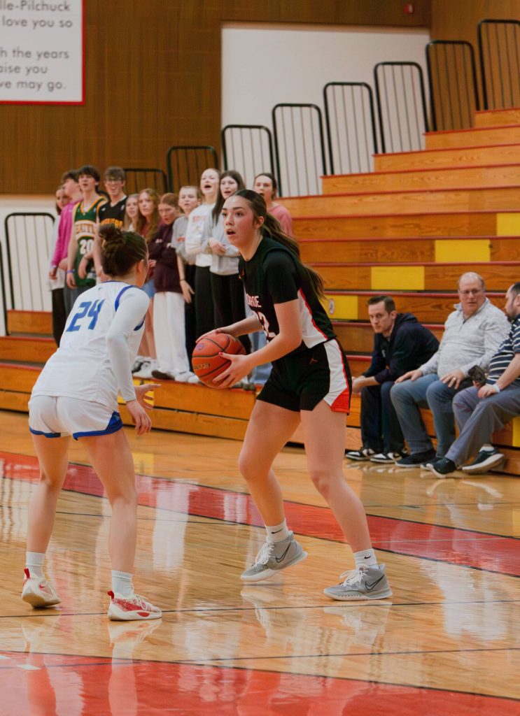Monroes Mya Mercille looks for an open teammate as Shorewoods Vanessa Spadafora plays defense during a Feb. 22, 2025 District 1 3A playoff game at Marysville Pilchuck High School. (Qasim Ali / The Herald)