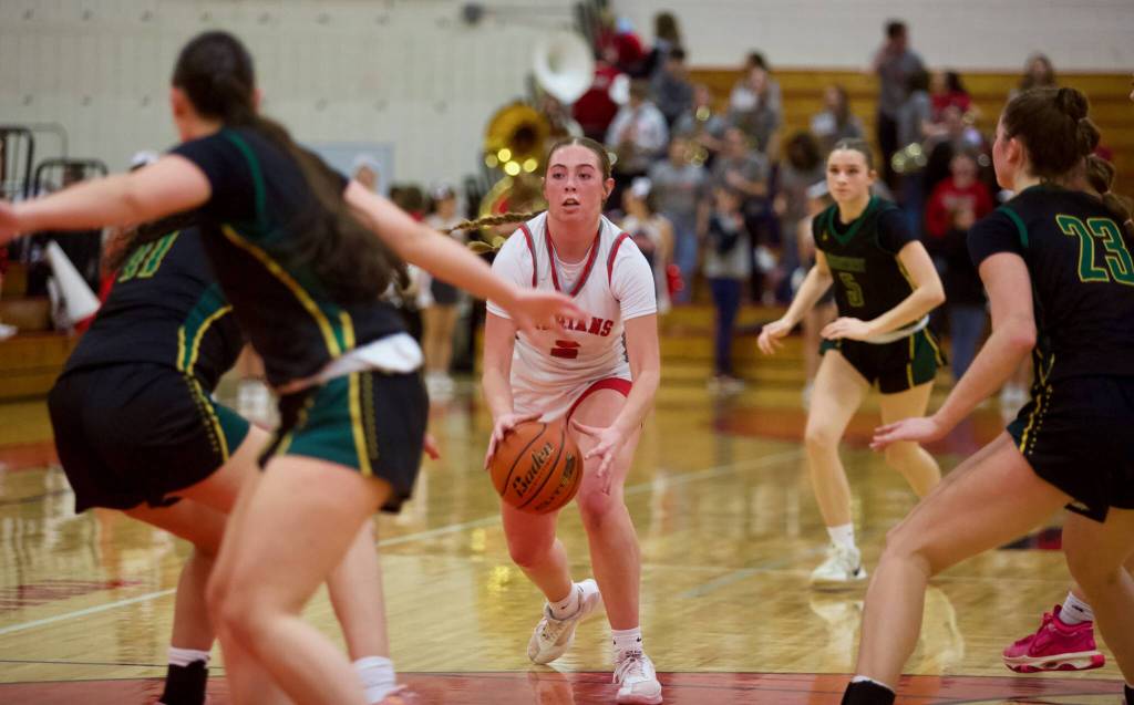 Stanwood junior Ellalee Wortham scans the court amid a sea of Shorecrest defenders during the District 1 3A Girls Basketball Championship in Marysville, Washington on Feb. 22, 2025. (Joe Pohoryles / The Herald)