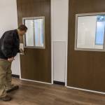 Chuck Steichen opens the door to one of the single occupant rooms on the second floor of the Lynnwood Crisis Care Center on Friday, Feb. 7, 2025 in Lynnwood, Washington. (Olivia Vanni / The Herald)