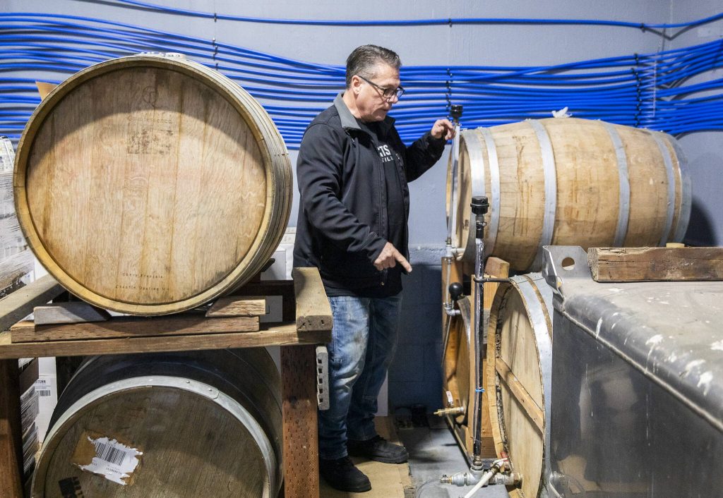 Robert Thompson talks about the different alcohols aging in barrels. (Olivia Vanni / The Herald)