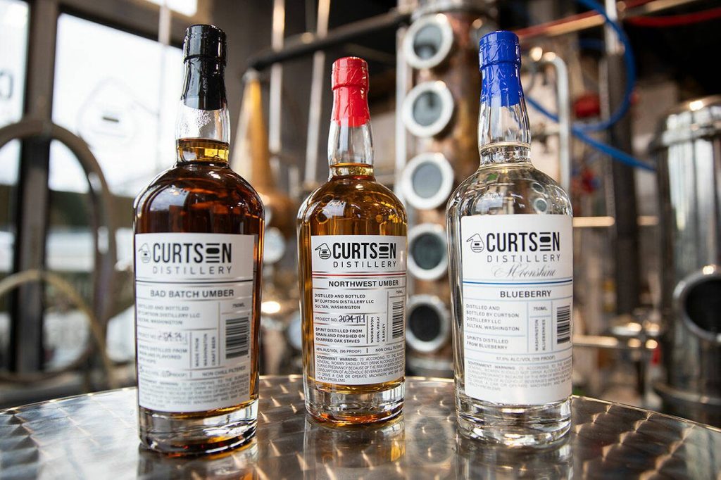 Curtson Distillery’s Bad Batch Umber, Northwest Umber and Blueberry Moonshine on Wednesday, Jan. 8, 2025 in Sultan, Washington. (Olivia Vanni / The Herald)