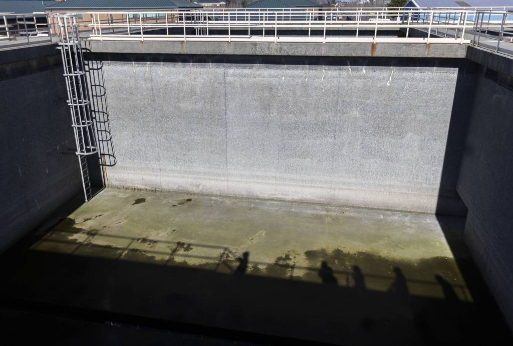 Shadows are cast across one of the Port Gardner Storage Facilitys 50-by-50, 30-foot-deep cement tanks on Thursday, Feb. 27, 2025 in Everett, Washington. (Olivia Vanni / The Herald)