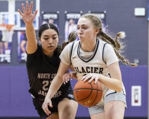 Glacier Peak’s Rikki Miller dribbles toward the basket during the 4A district loser-out playoff game against North Creek on Thursday, Feb. 20, 2025 in Kirkland, Washington. (Olivia Vanni / The Herald)