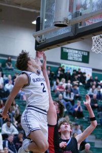 Glacier Peak's Jo Lee makes a contested layup during a Feb. 28, 2025 4A state playoff game against West Valley at Jackson High School. (Qasim Ali / The Herald)