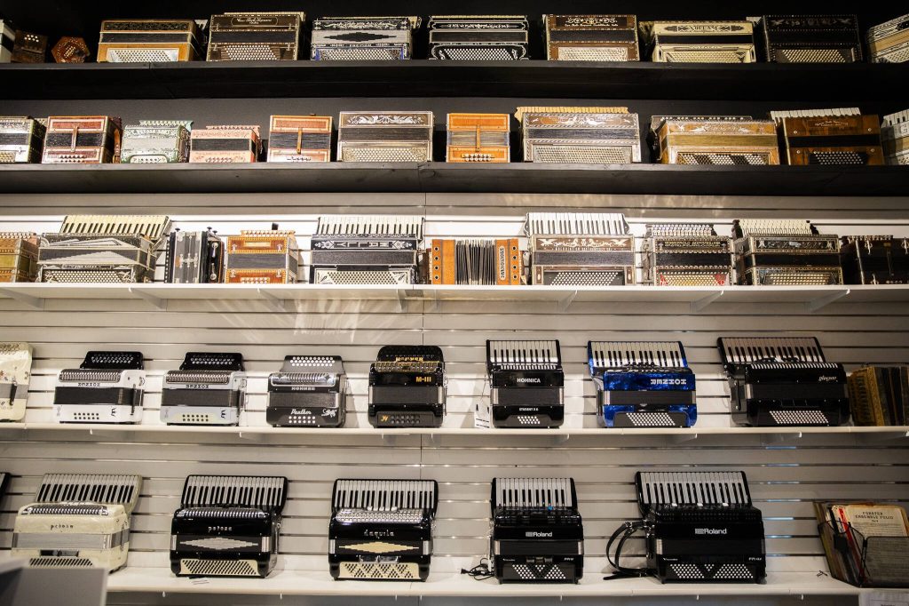 Accordions cover the wall inside the Petosa Accordions store. (Olivia Vanni / The Herald)