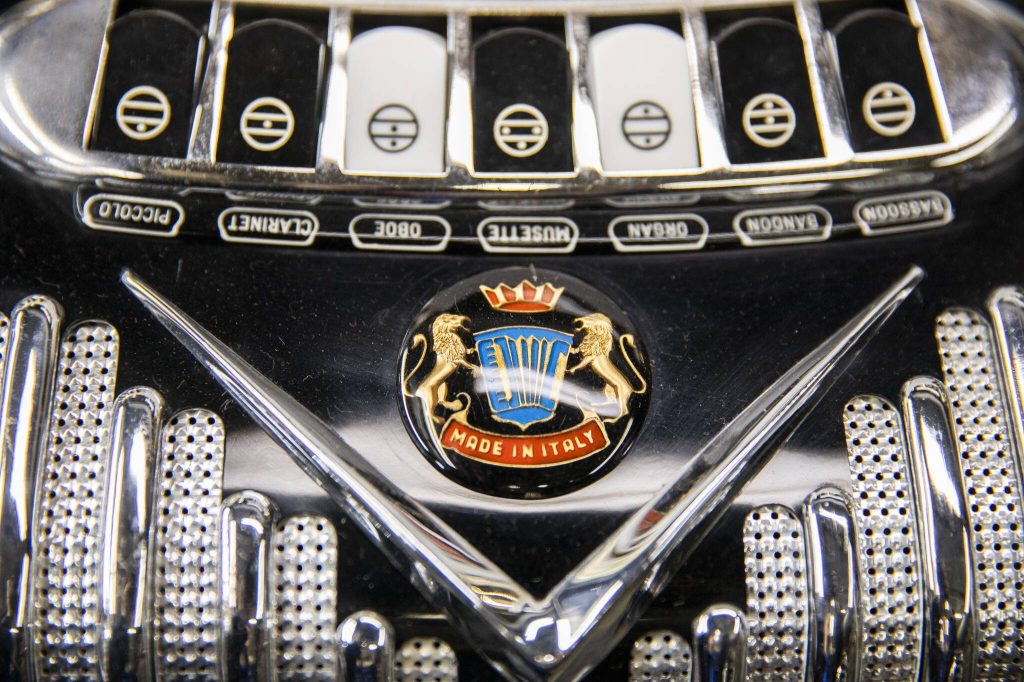 A large crest is visible on the outside of an accordion. (Olivia Vanni / The Herald)