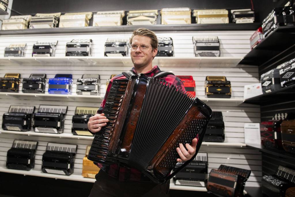 Josiah Burkman plays an accordion inside of the Petosa Accordions store on Wednesday, Dec. 11, 2024 in Everett, Washington. (Olivia Vanni / The Herald)