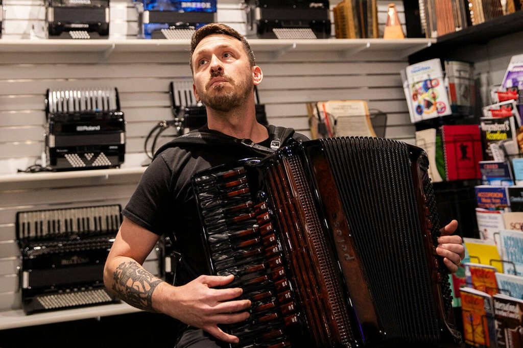 Gabe Hall-Rodrigues plays an accordion inside of the Petosa Accordions store on Wednesday, Dec. 11, 2024 in Everett, Washington. (Olivia Vanni / The Herald)