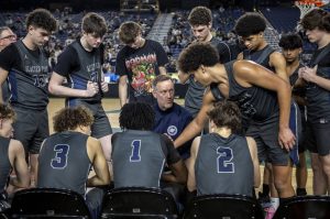 Glacier Peak players huddle during a 4A semifinal game between Glacier Peak and Richland at the Tacoma Dome on Friday, March 1, 2024 in Tacoma, Washington. (Annie Barker / The Herald)